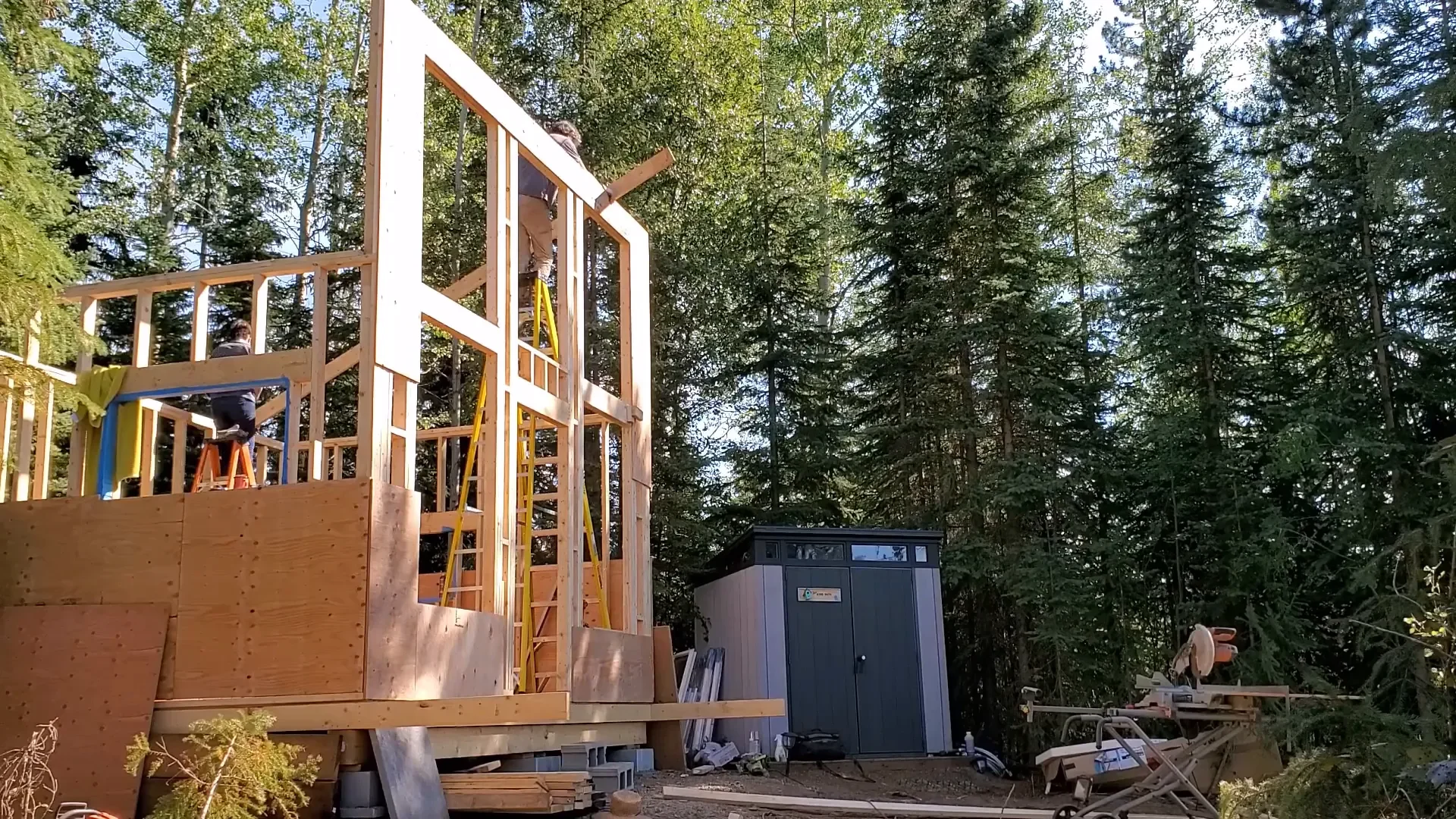 Husband builds wife goes fishing - ryan putting the roof on the cabin