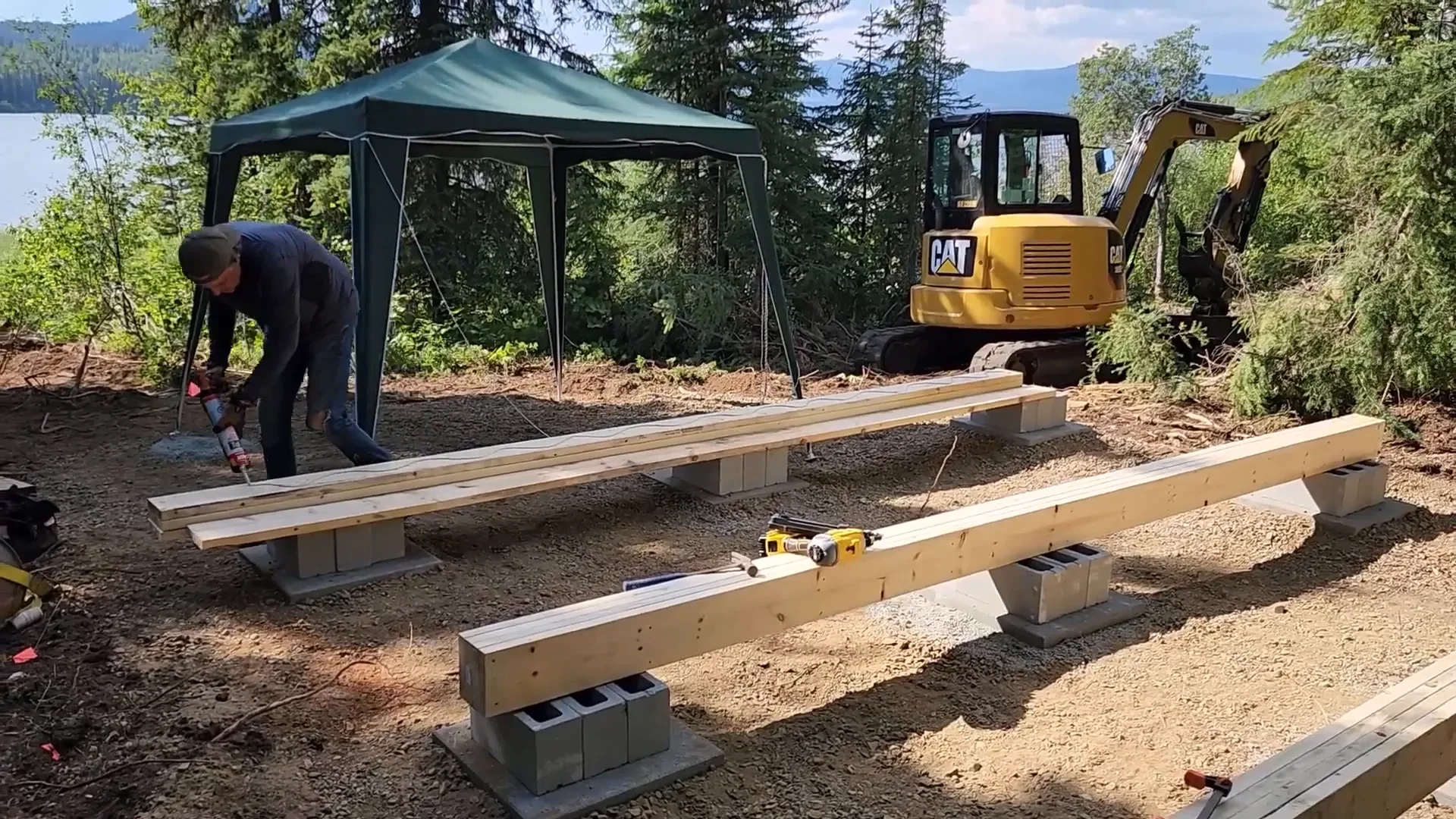 Amazing shed move - support beams being placed over foundation piers