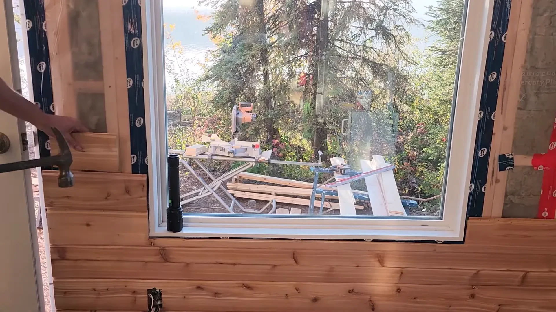 Installing cedar siding in the cabin