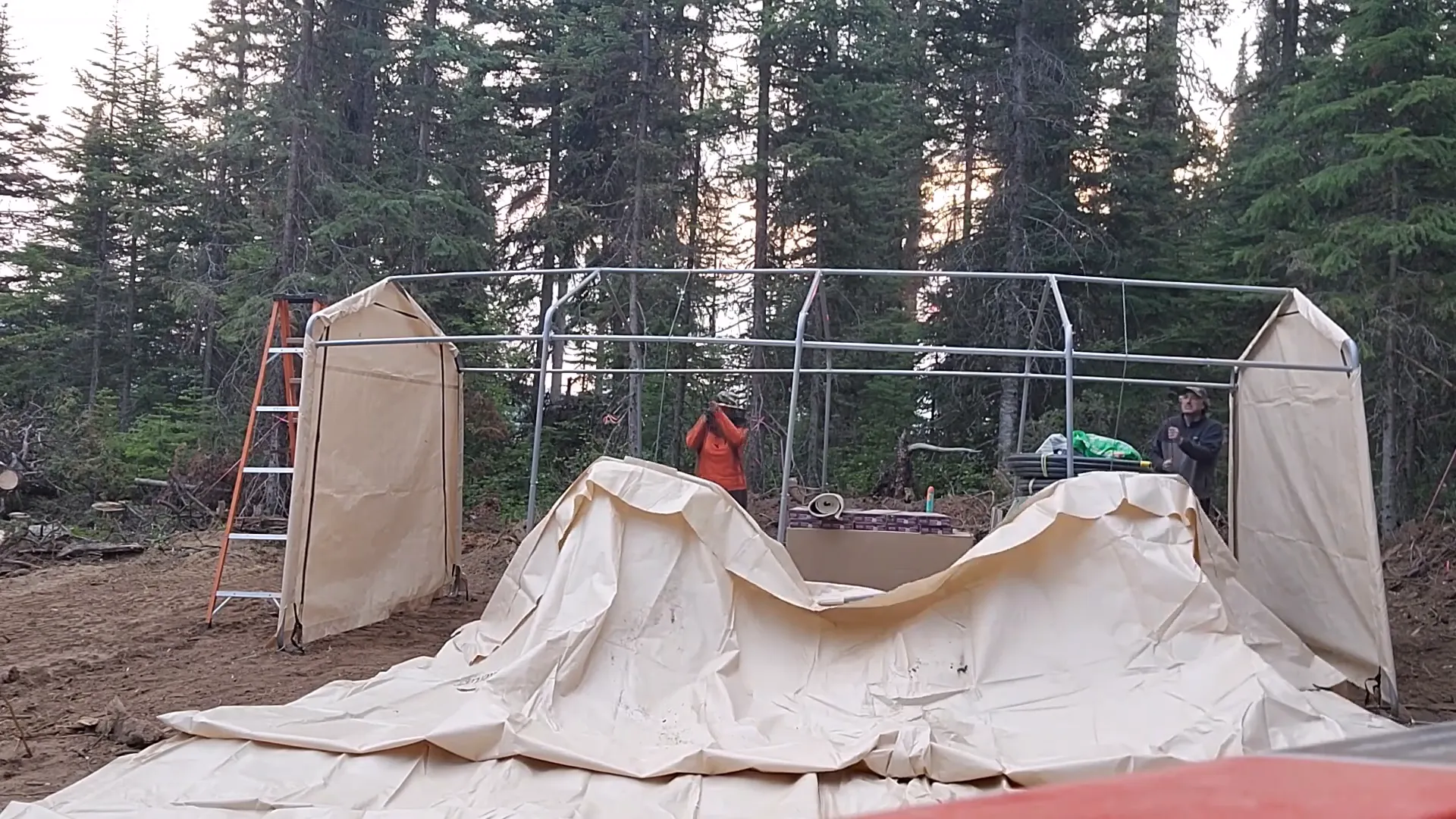 Why We Built a Shelter in the Woods - S2 Ep11 3 A man and woman assemble a shelter kit in the woods