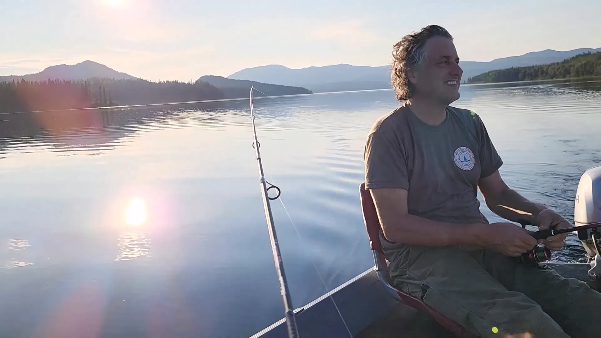 Off Grid Cooking: Simple, Succulent Rainbow Trout! - S2 Ep25 3 A man relaxing while fishing on a beautiful lake on a summer evening