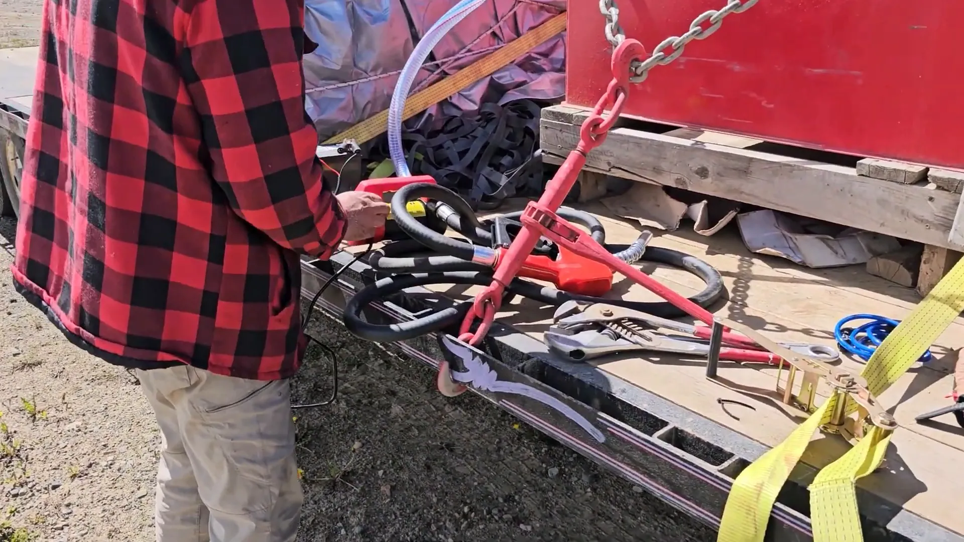 Off-Grid Island Winter Damage: What’s Still Standing? | S3 Ep2 1 A man fiddles with a 12v diesel pump on an off-grid island
