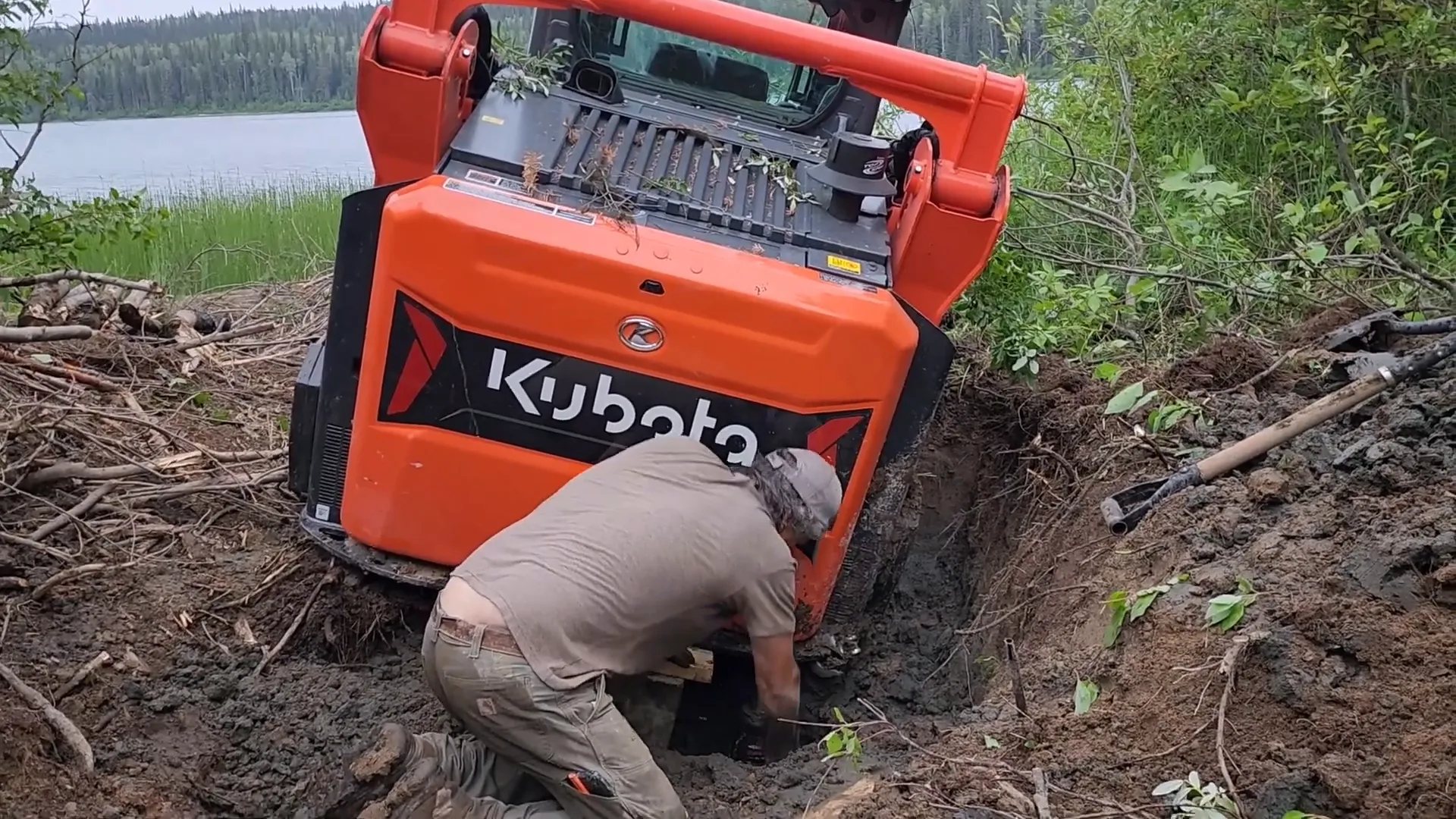 Is Our Toughest Task Too Tough? - S2 Ep27 2 A man works to free a stuck track loader