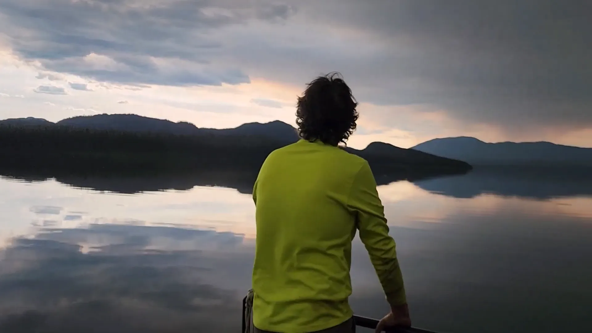 Truck smashed again - while a man looks across a calm lake of glass, like a mirror finish