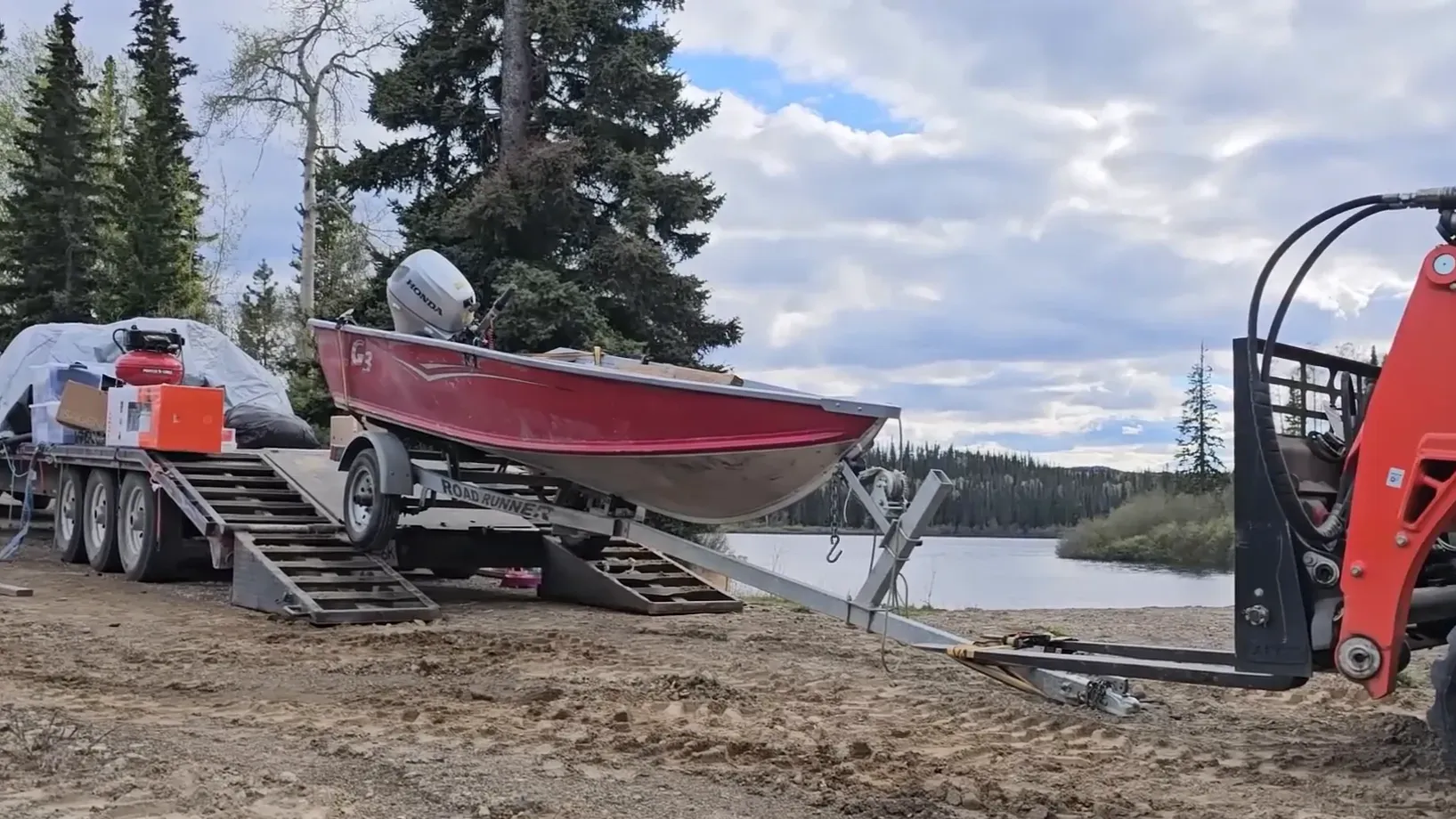 Our off-grid life - a kubota pulls a skiff off a large trailer