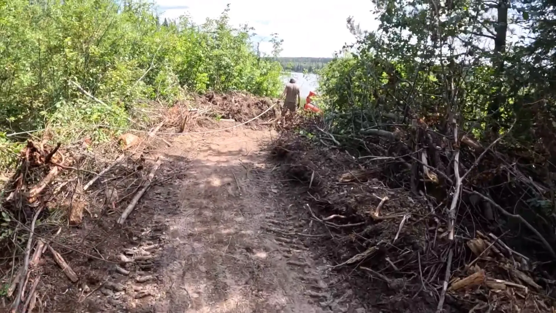 This is Our Toughest Task So Far - Will We Succeed? - S2 Ep26 3 A man drags a winch cable towards a stuck piece of equipment
