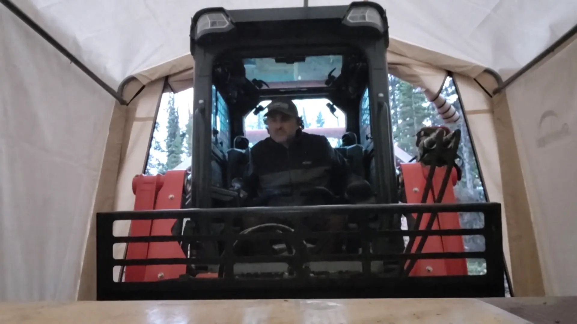 Why We Built a Shelter in the Woods - S2 Ep11 6 A man drives a track loader into a temporary shelter in the woods