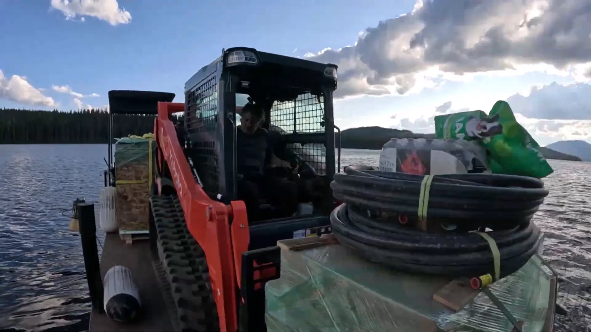 Why We Built a Shelter in the Woods - S2 Ep11 1 A kubota track loader on a lake barge with other equipment