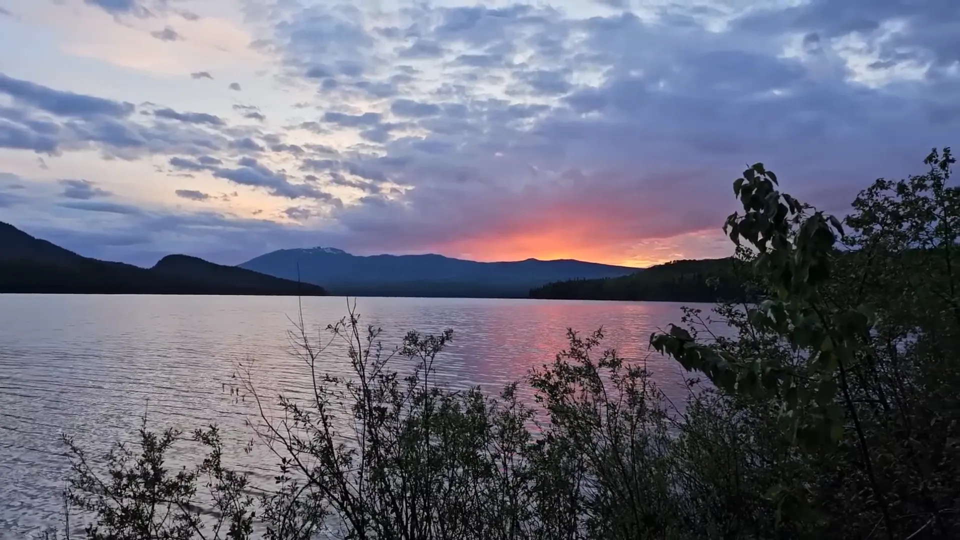 A beautiful sunset across the lake to the mountains