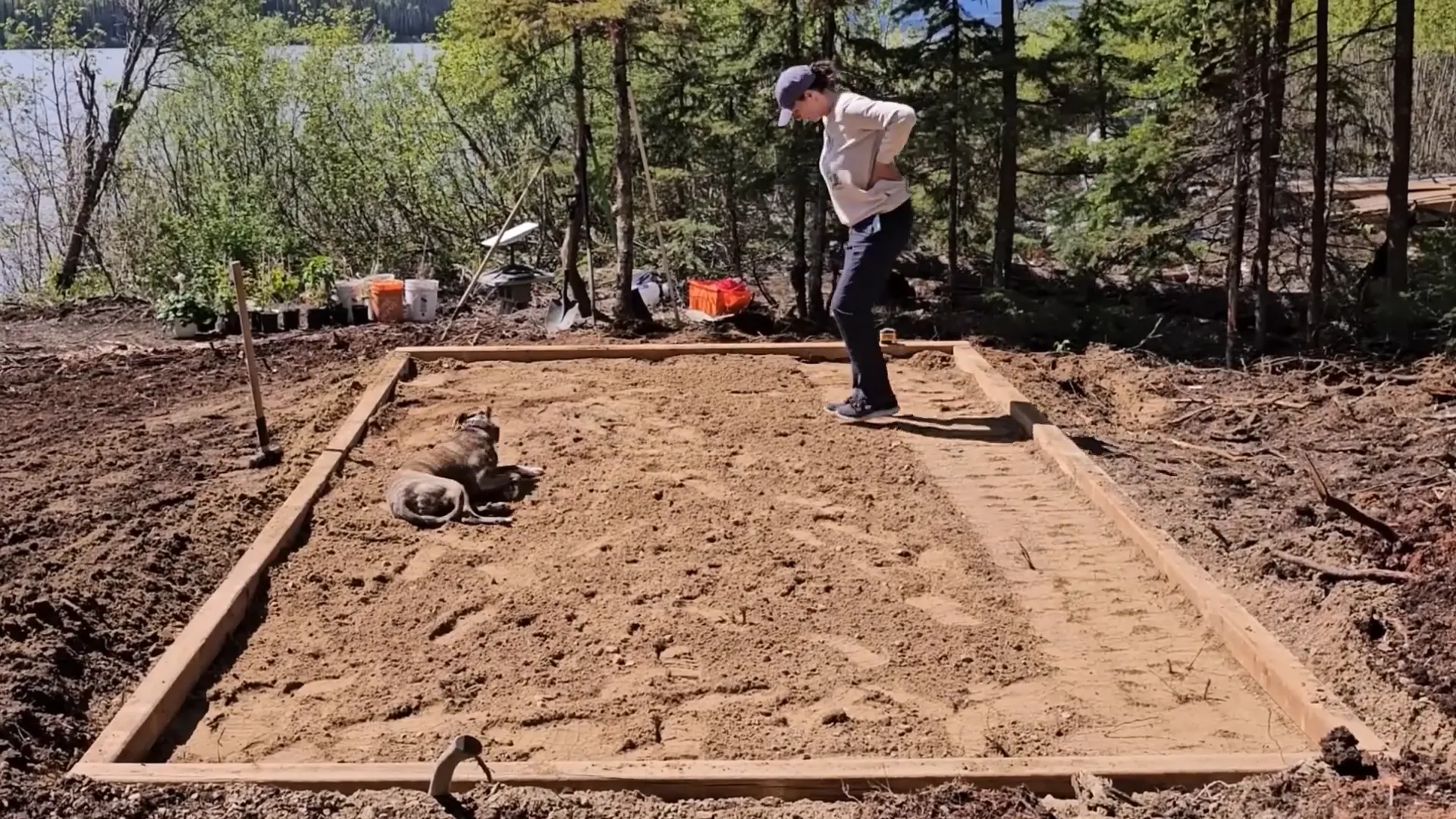 A woman is doing a riverdance on a big bed of sand, to flatten it out