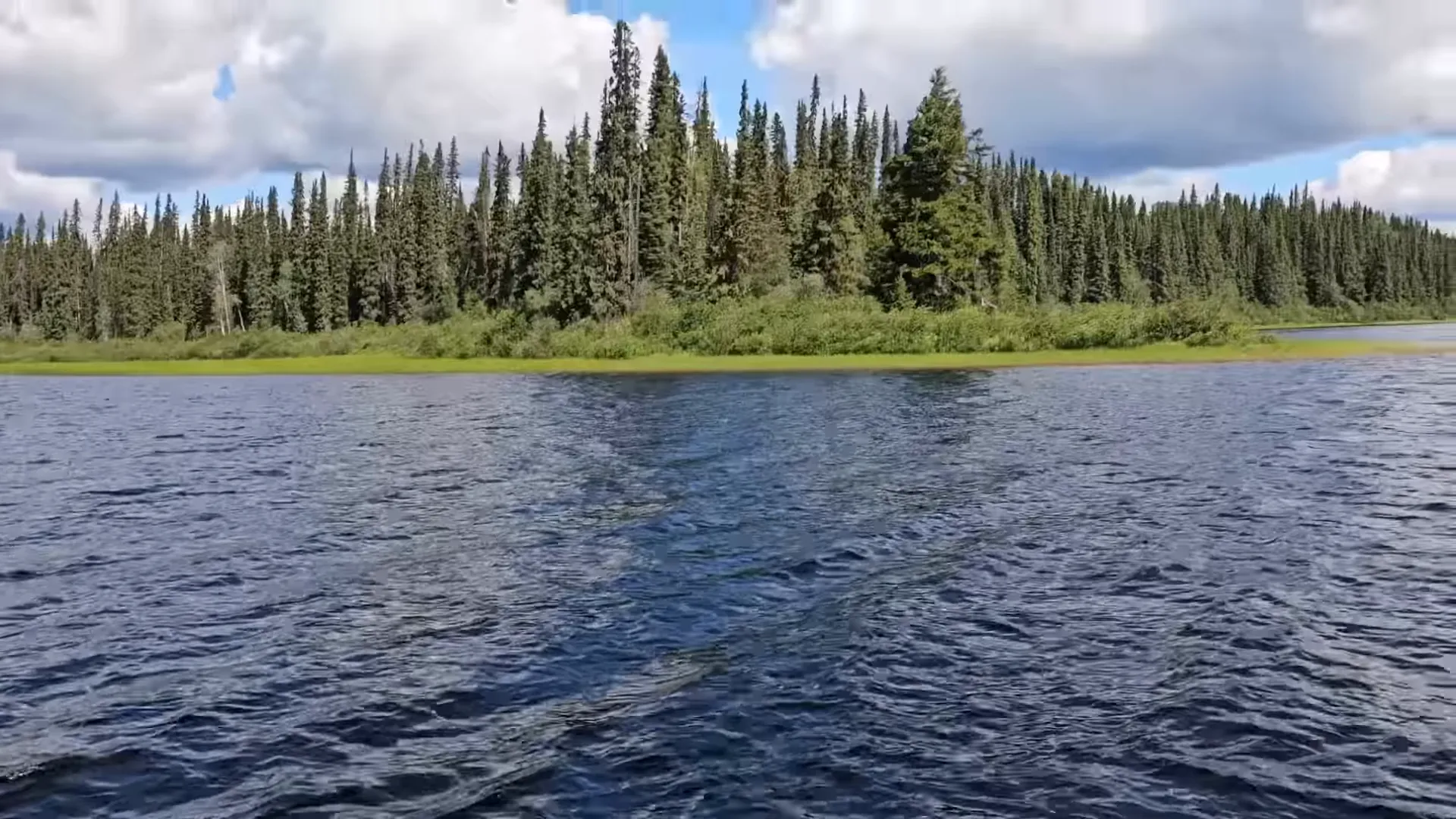 Driving away from the island on the logging road with the flag flying
