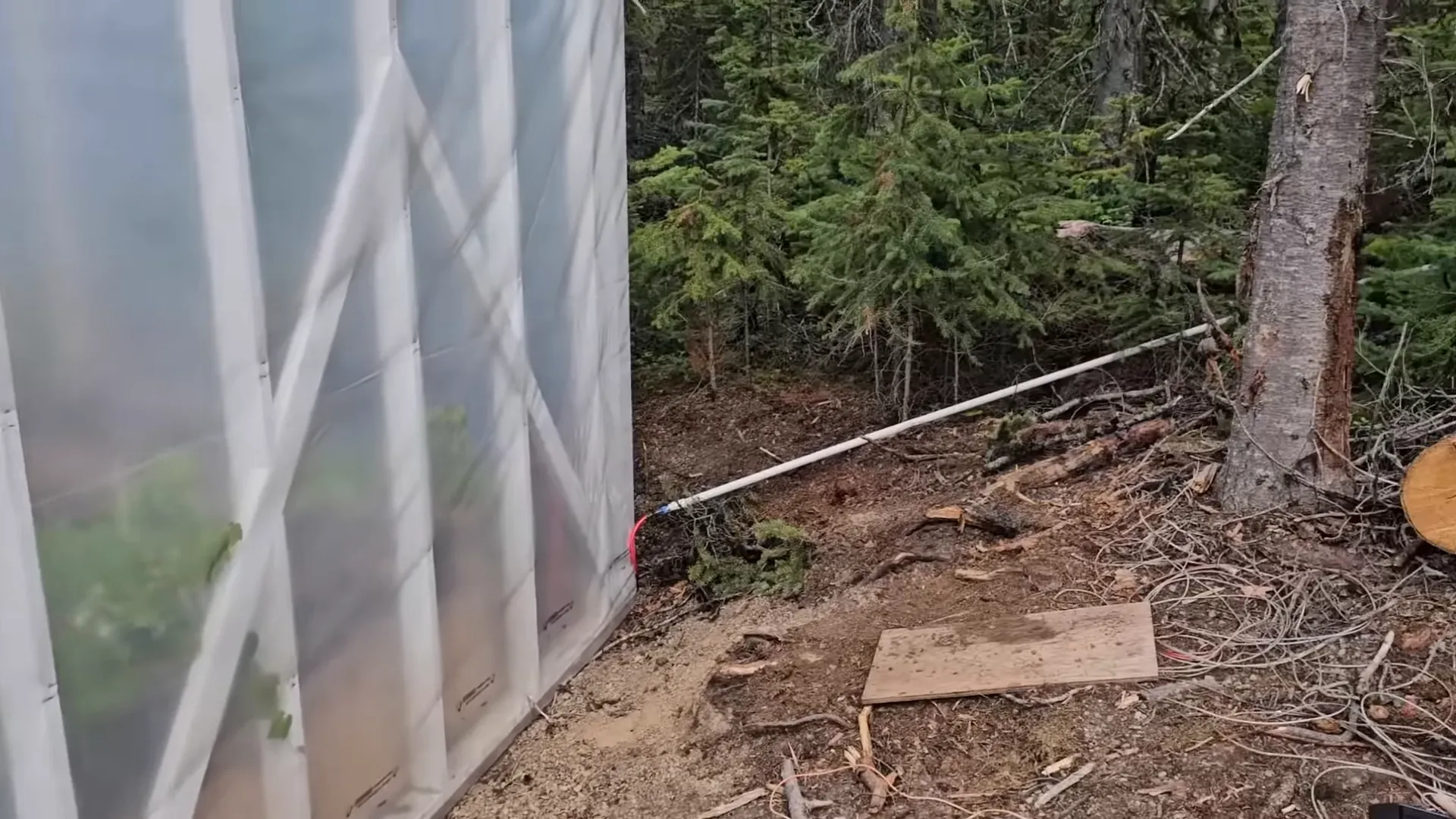 New pipe spigot stub installed next to greenhouse beds