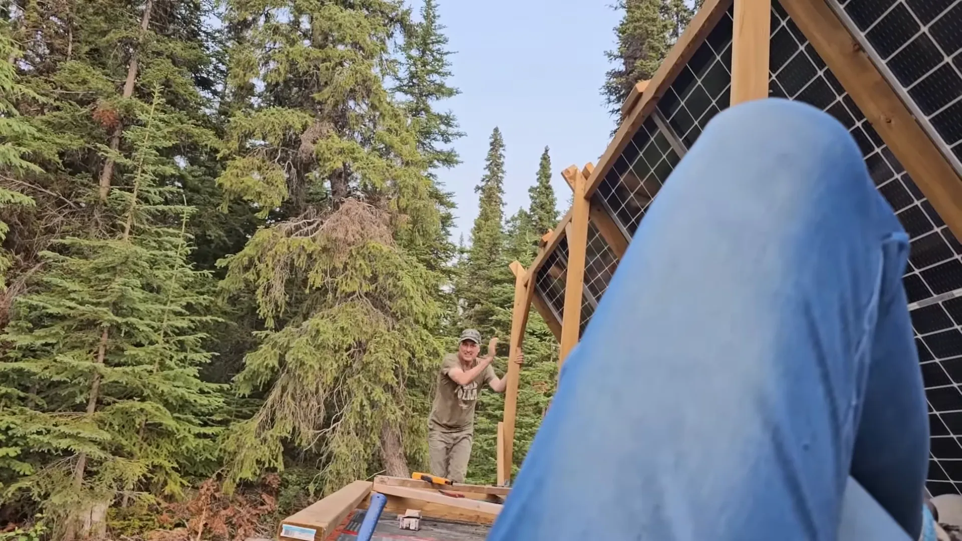 Melodi leaning over the roof edge to get a camera angle