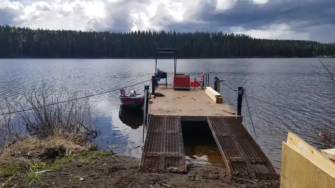 Off grid life on a remote island in canada – solar power, swamped boat & beating the storm - scaffolding materials stacked on shore