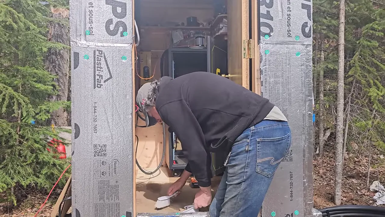 Off grid life on a remote island in canada – solar power, swamped boat & beating the storm - close-up of battery installation