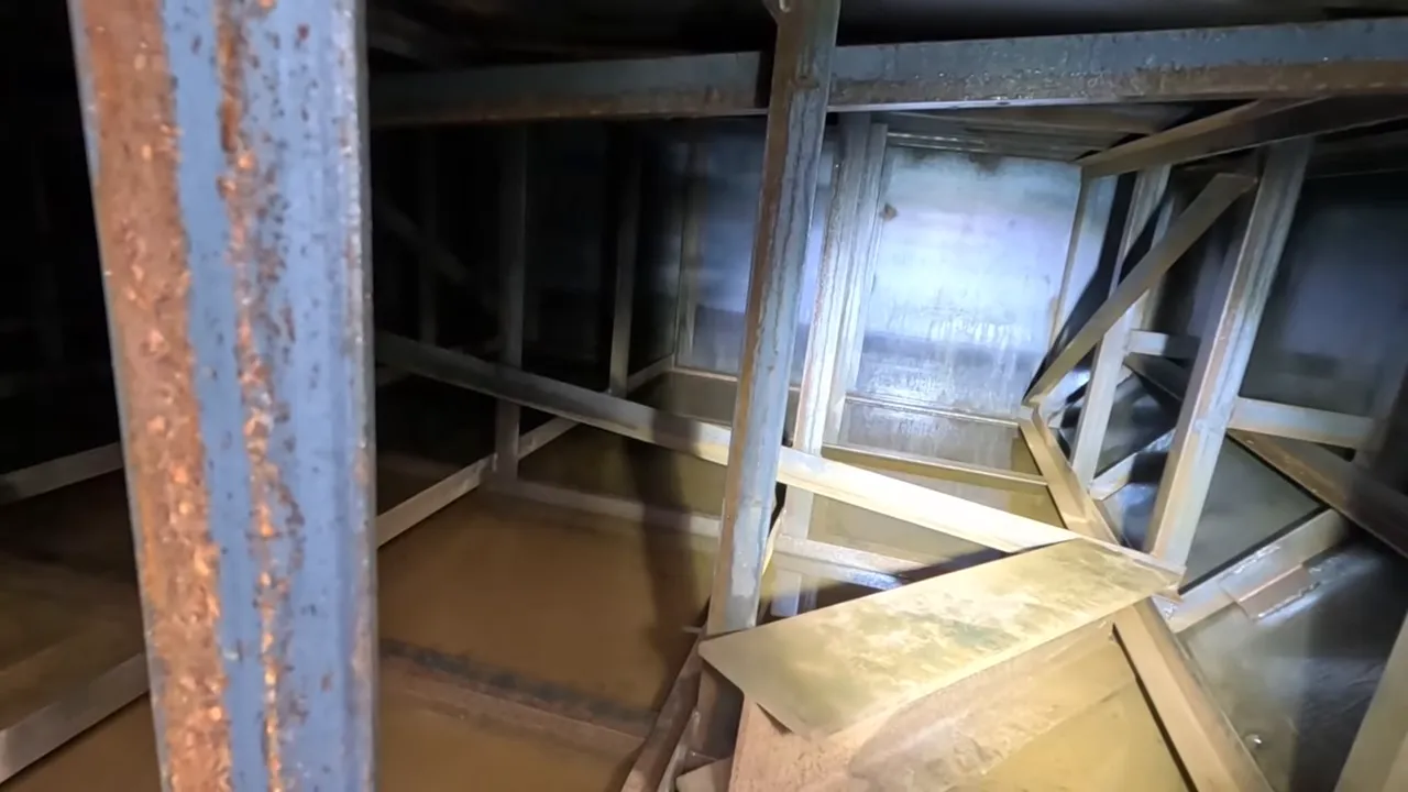 Off Grid Cabin Build: Facing Fears on Homemade Scaffolding After My Bad Fall | S4 Ep9 5 Interior of barge hull with clear view of steel framing and shallow standing water during inspection