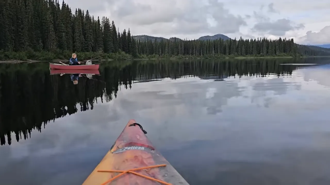 Black Bear Encounter on Our Remote Island – Our Dog Chases a Huge Bear Up a Tree! – My Wild Holm S3 Ep26 4 We thought our remote wilderness island was bear-free. We were wrong! - canoe on a glassy lake with fishing rods out