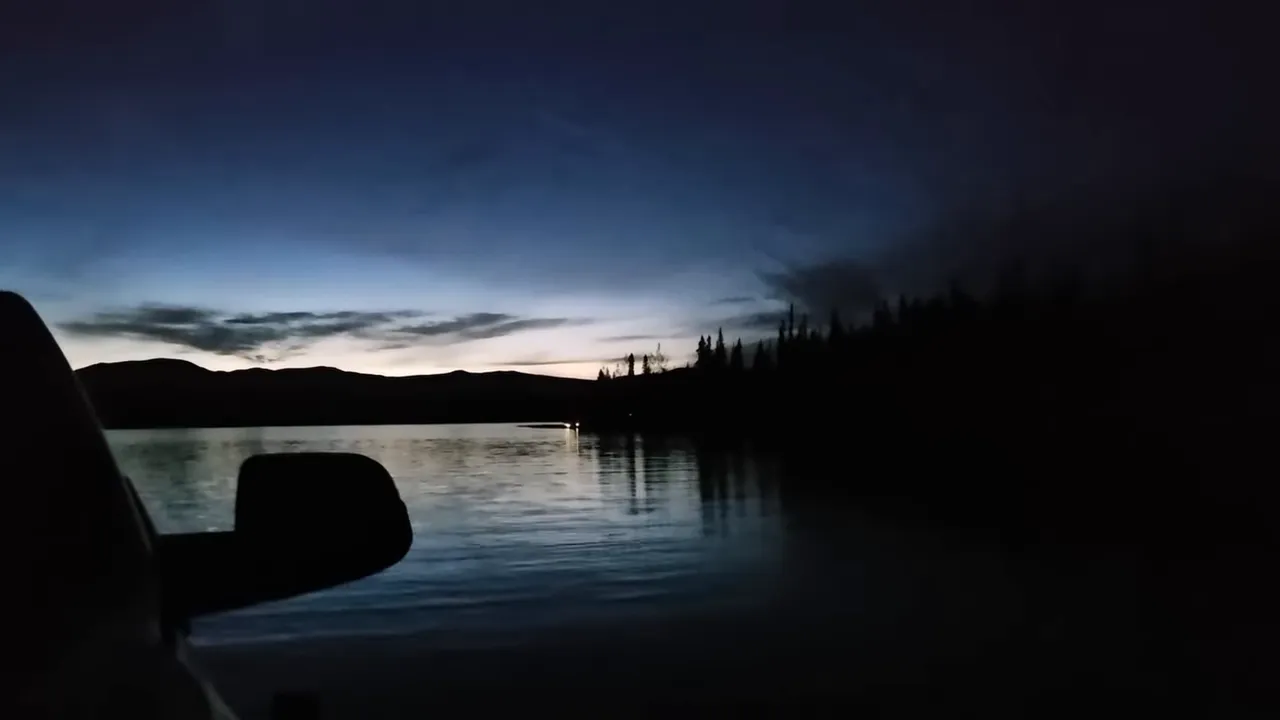 Welding the anchor for a huge solar tracker - barge crossing at sunset with lumber and truck