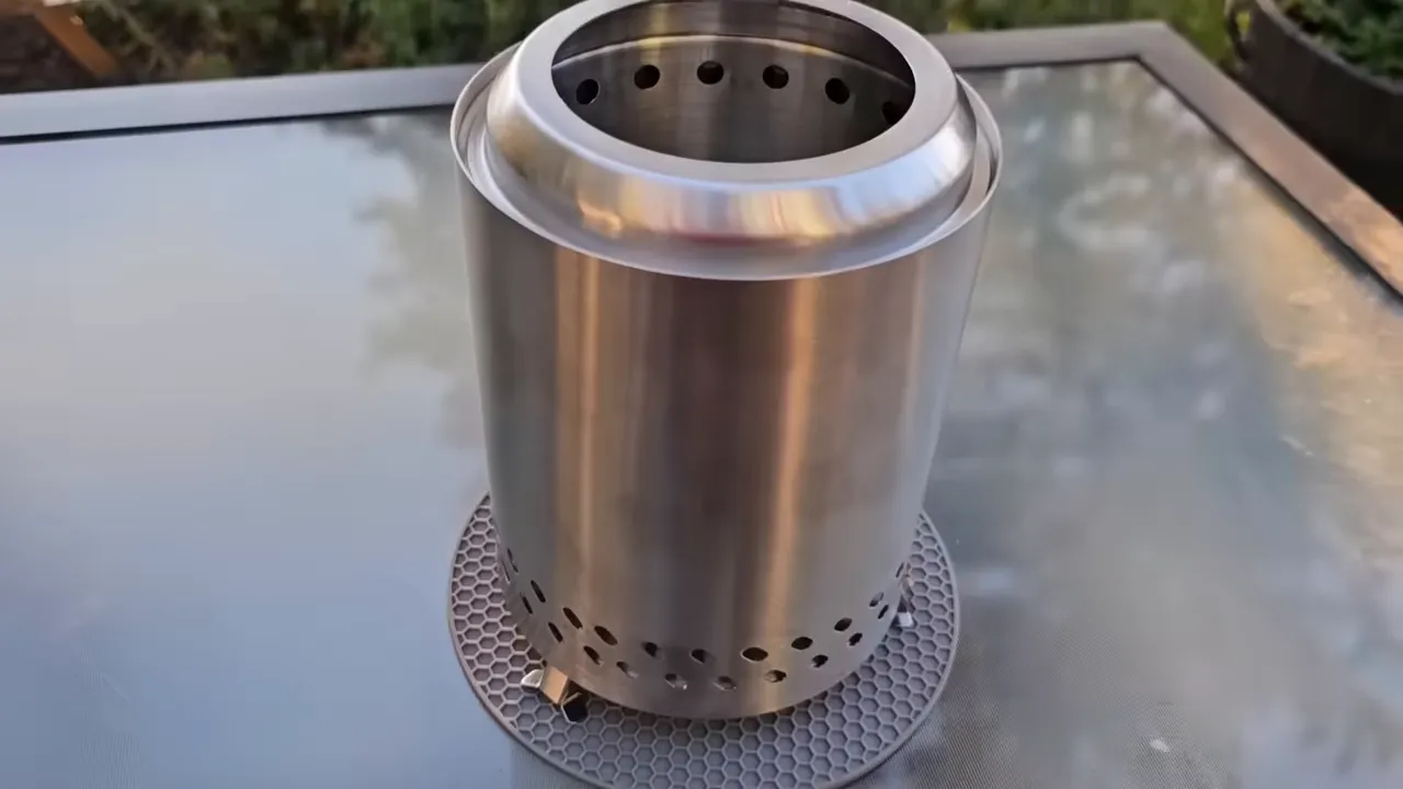 Stainless tabletop smokeless fire pit on a tiny cabin deck