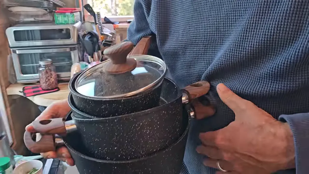 Cooking pot on the stove as items are cleared inside a small off-grid cabin