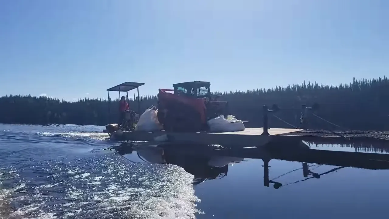 Barge carrying construction materials and supplies across a remote lake