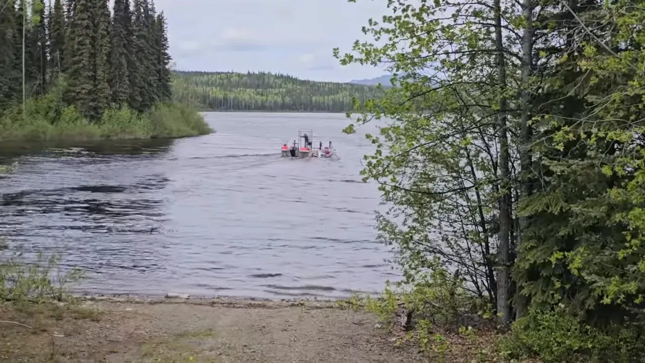Barge pulling away from a sandy shore with forested lake and trees framing the scene