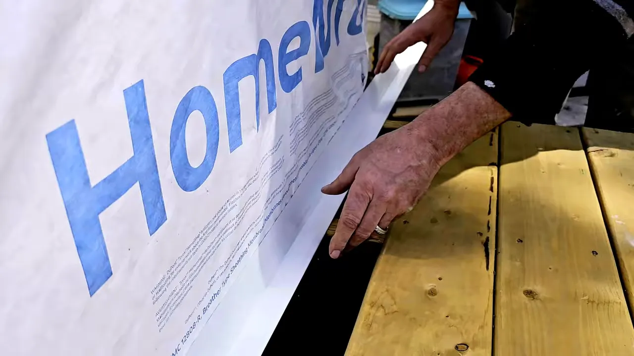 Explaining how house wrap will overlap flashing to direct water