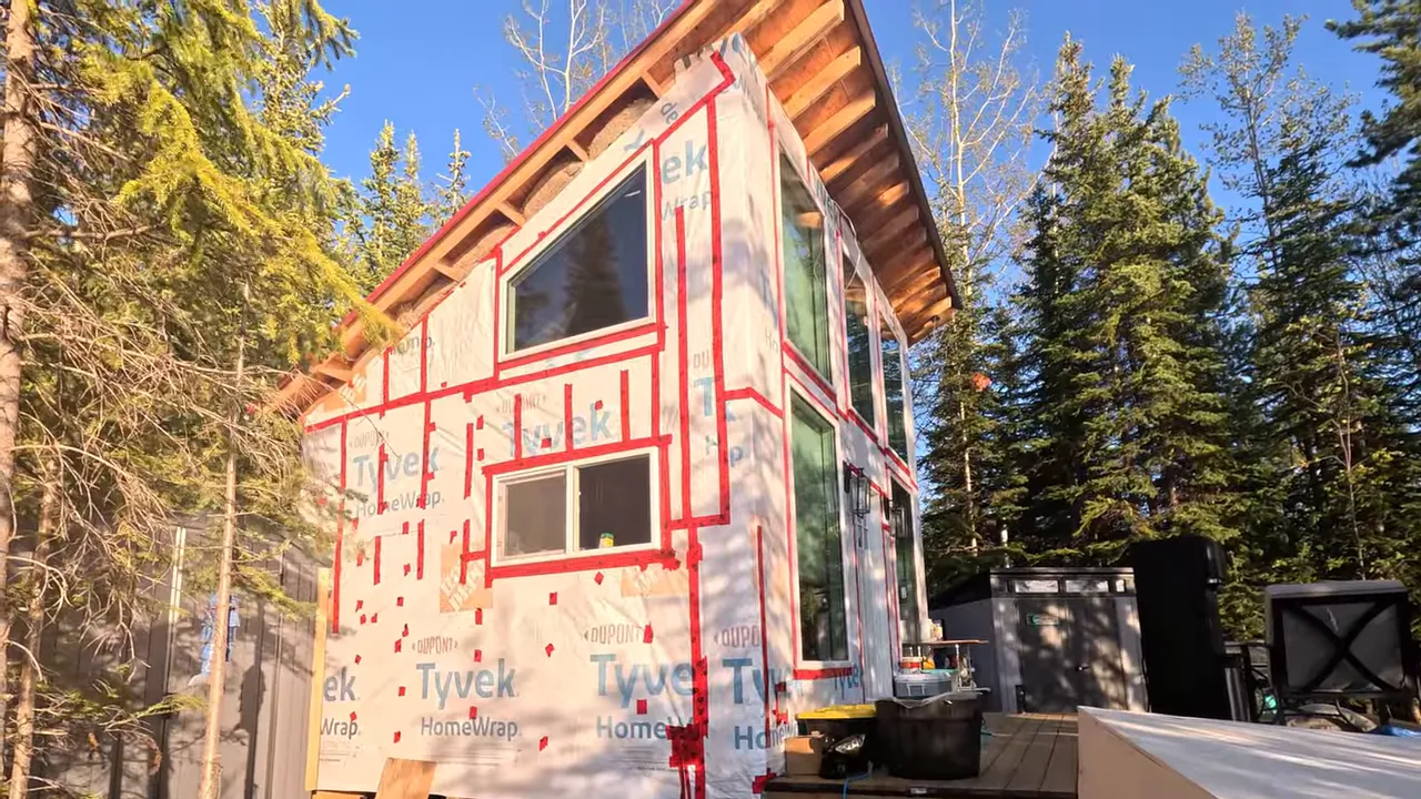 Cabin exterior with trim layout planned; discussion about siding materials